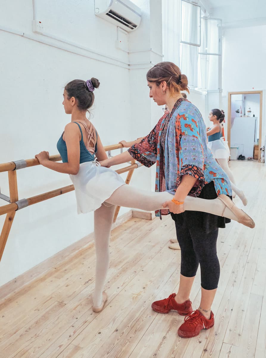 Stella working with a dancer at the barre